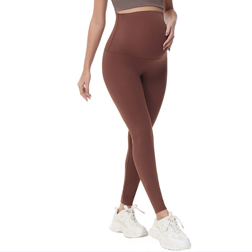 Pregnant Brown leggings worn by a person on a white background