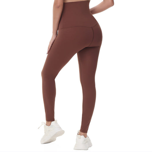 Pregnant Brown leggings worn by a person on a white background